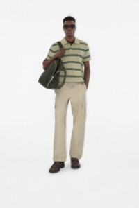 模特身穿Burberry格纹Polo衫，手持Burberry格纹双肩包