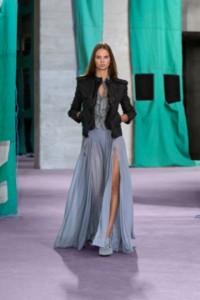 Model wearing bomber jacket in black, with silk short sleeve shirt in magnet and viscose jersey maxi skirt in gale.