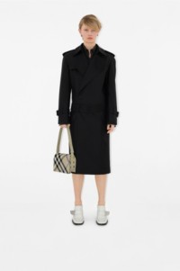 Model wearing Burberry black outfit with check snip bag